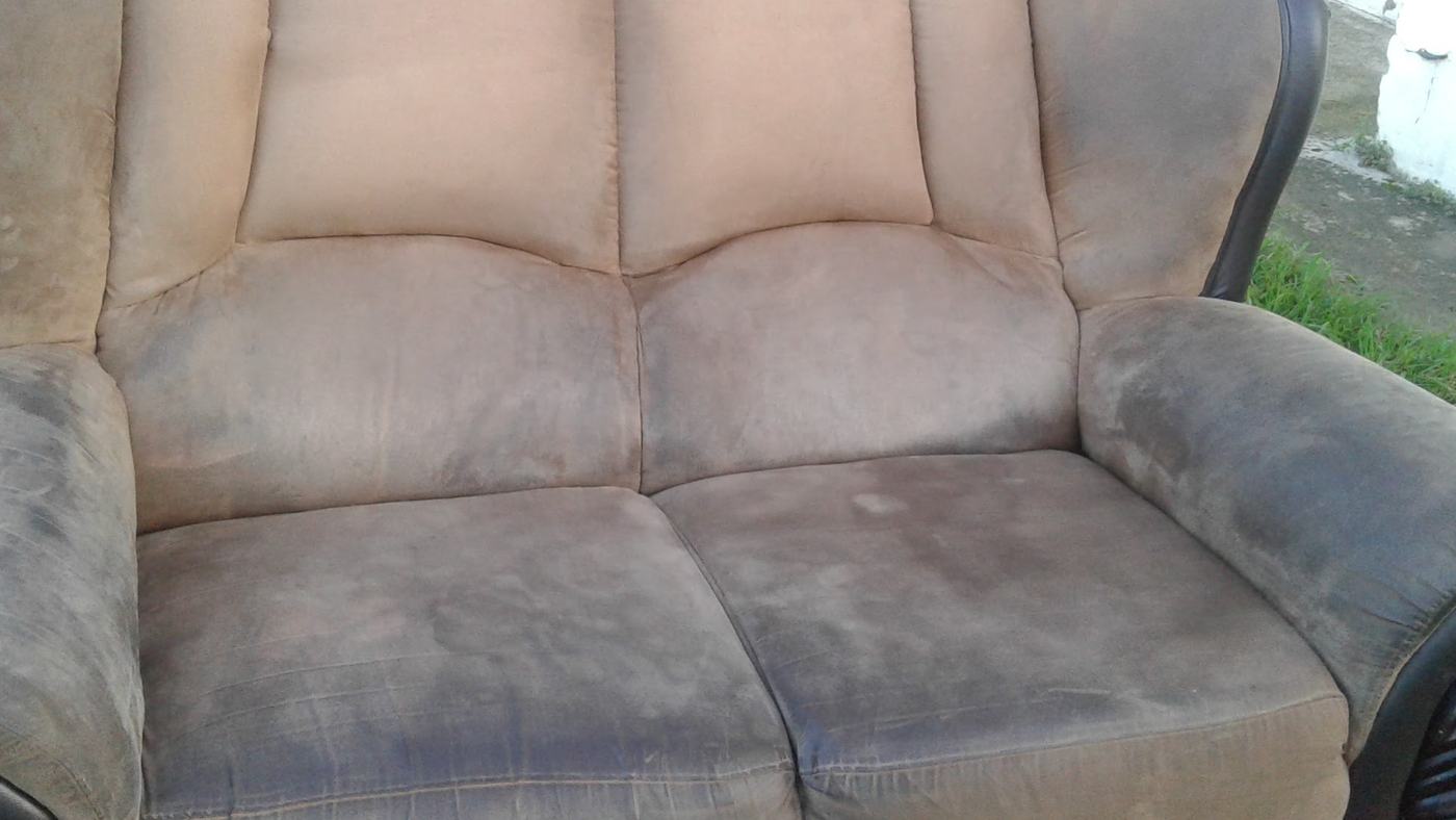 A suede recliner before cleaning, the arm and the seat darkened from years of use